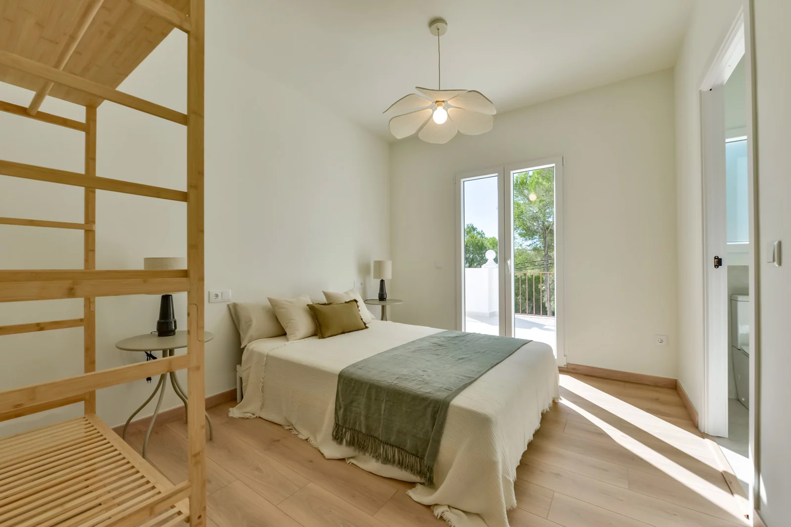 Guest bedroom with balcony access and natural light in Costa Blanca villa